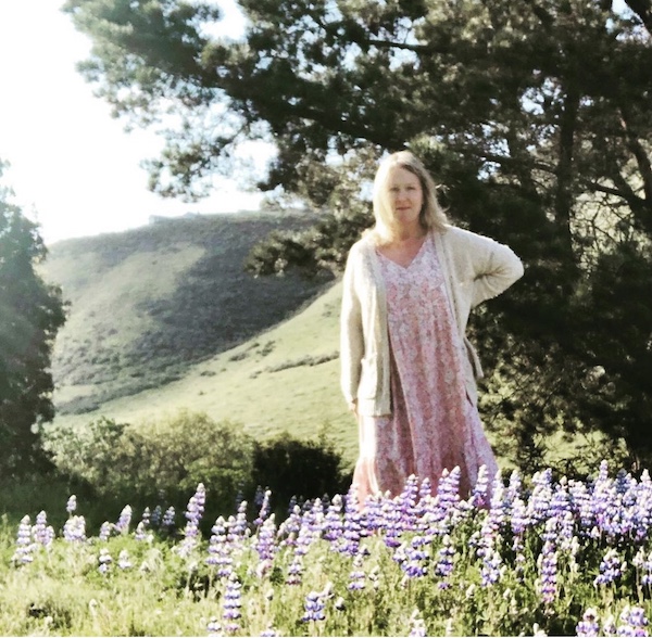 Monterey Farmgirl in her flowery dress in a pastoral setting on her farm in 2020.